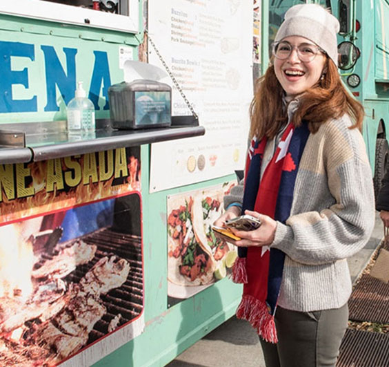 Image of woman standing at food truck